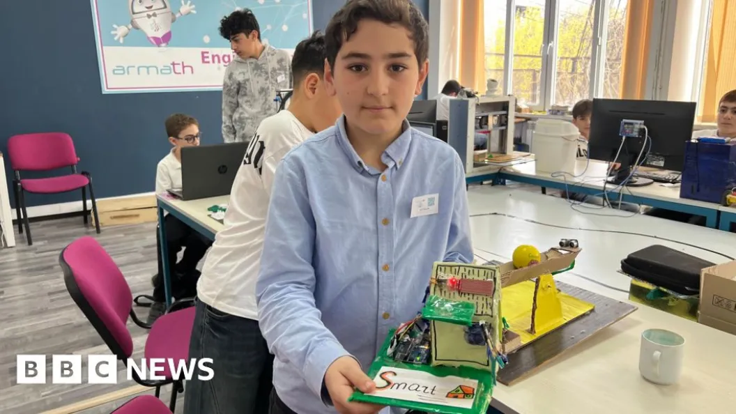 Nine-year old Slavik is demonstrating his invention - a box with three LED lights.